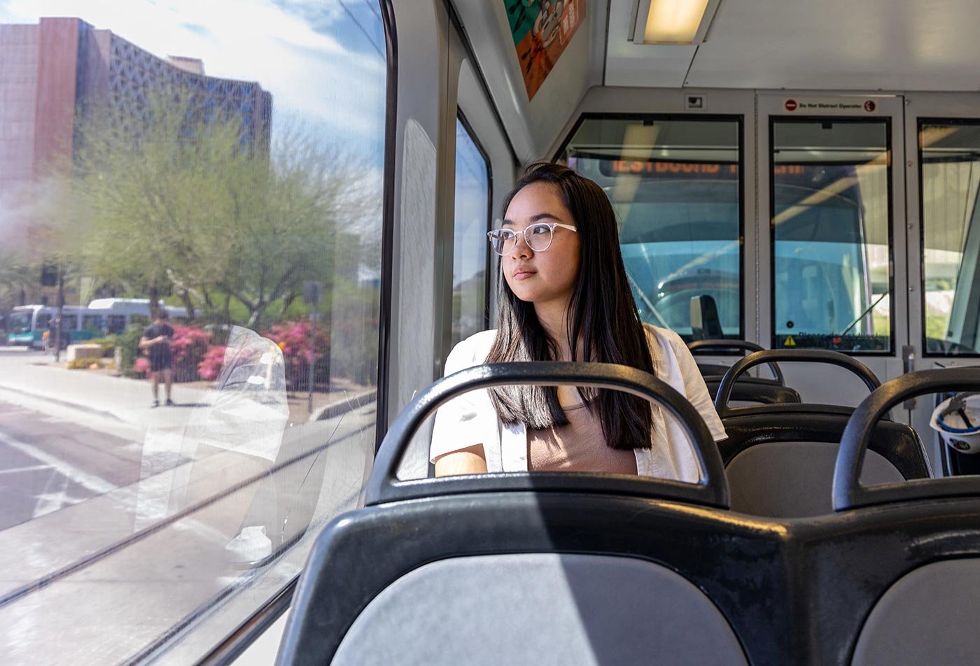 Master's student in Community Resources and Development  (Sustainable Communities) observes the city from public transit.