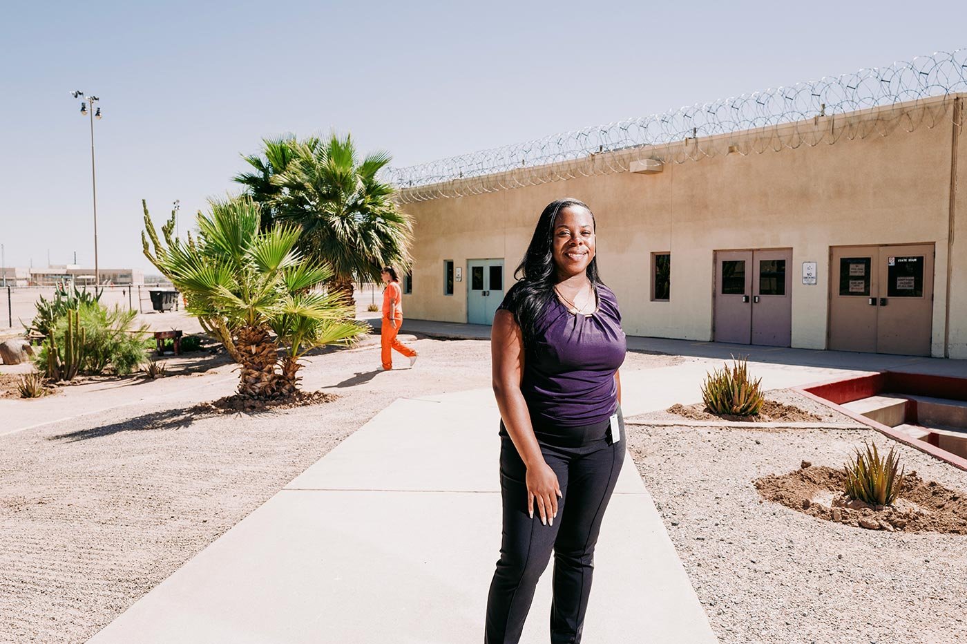 A student stands outside a correctional facility, showcasing vital experiences relevant to ASU's Criminology and Criminal Justice, PhD program.