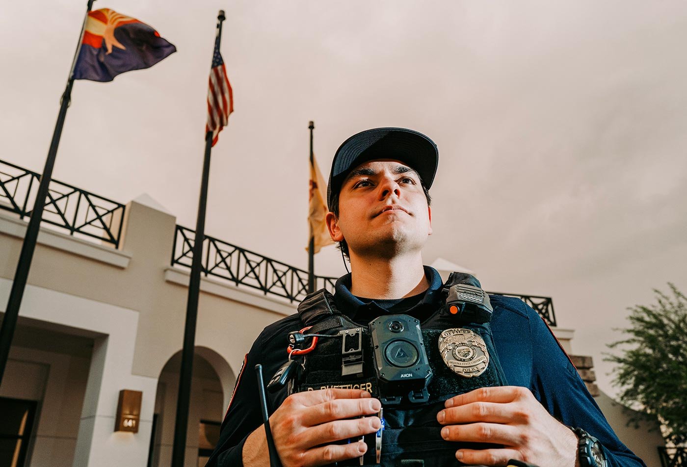A security officer stands outside a building, representing the real-world policing focus of ASU's Criminal Justice degree.