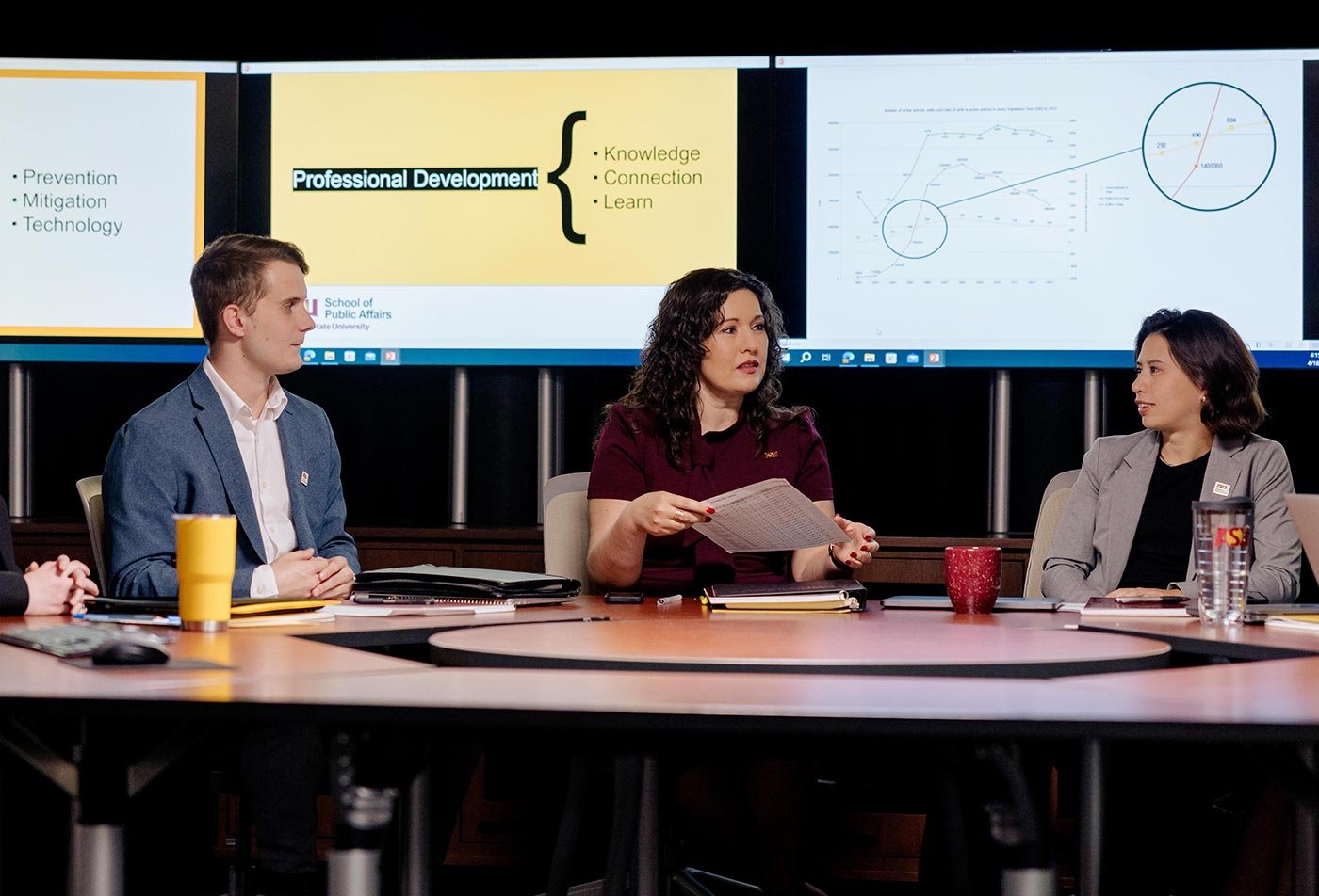 Students discuss urban heat management strategies around a table, reflecting the practical skills built in this Cross-Sector Leadership certificate.