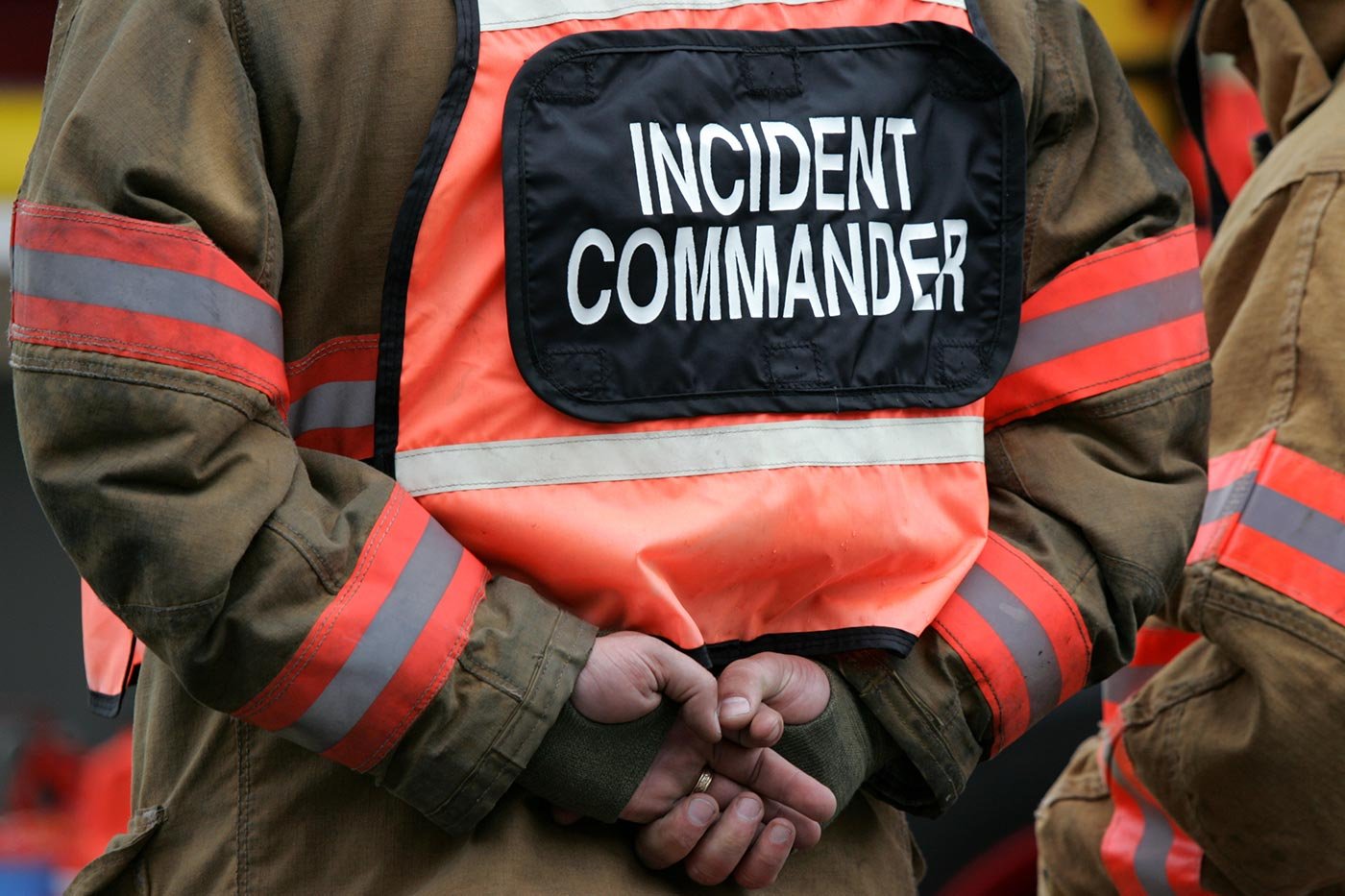 A firefighter wears an orange vest labeled "Incident Commander," demonstrating leadership roles in ASU’s Emergency Management degree.