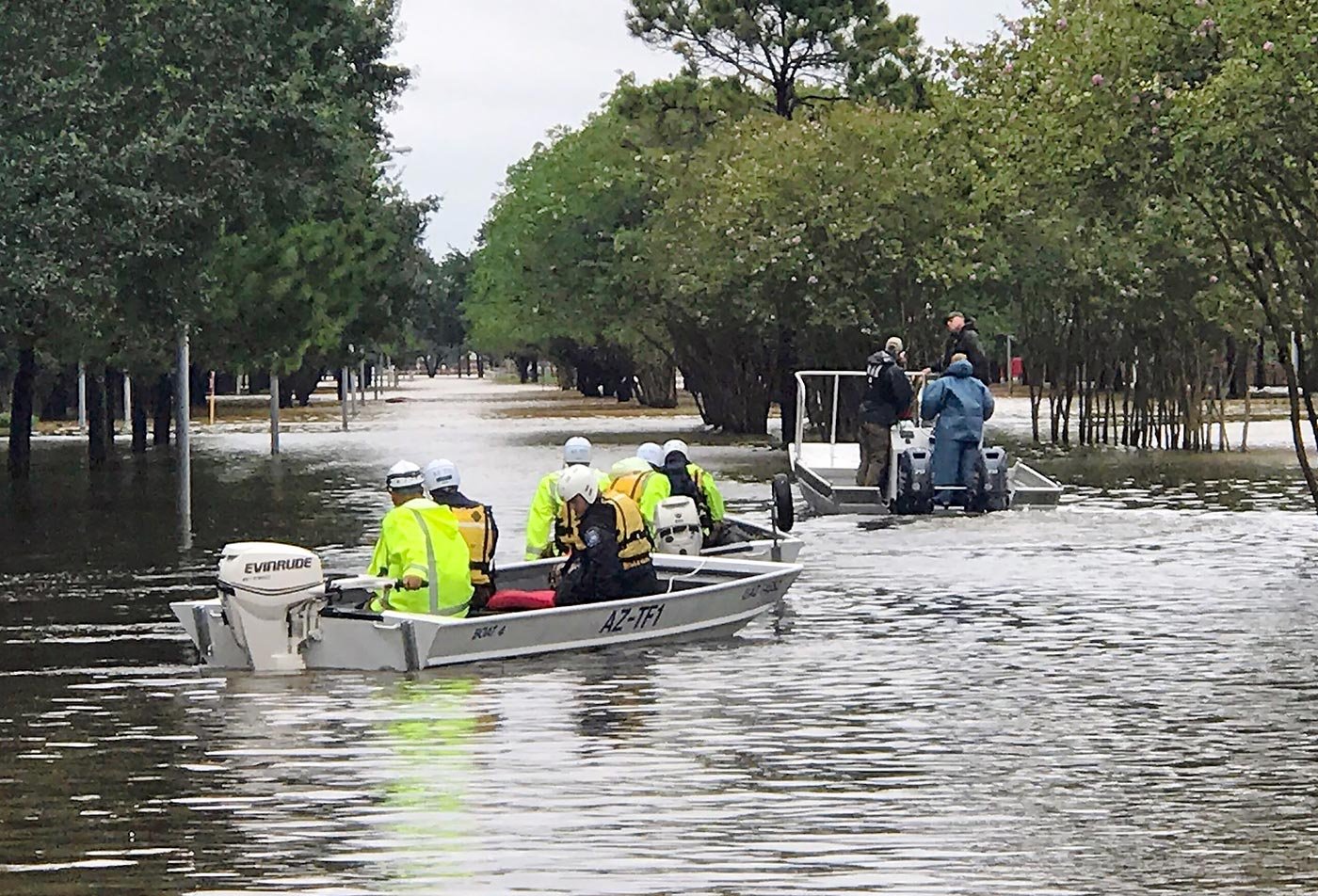 Rescuers navigate a flooded area by boat, reflecting the resilience-building skills central to this ASU concentration.