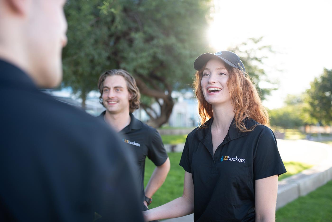 Three young adults chat animatedly outdoors, echoing the community focus of ASU's Nonprofit Leadership and Management degree.