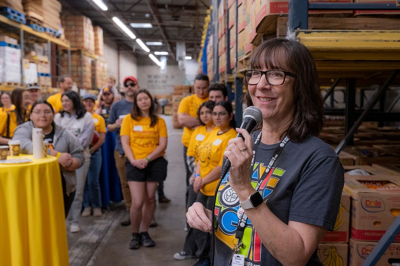 Students and community members celebrate at a warehouse event related to the MNLM in Nonprofit Leadership and Management program.