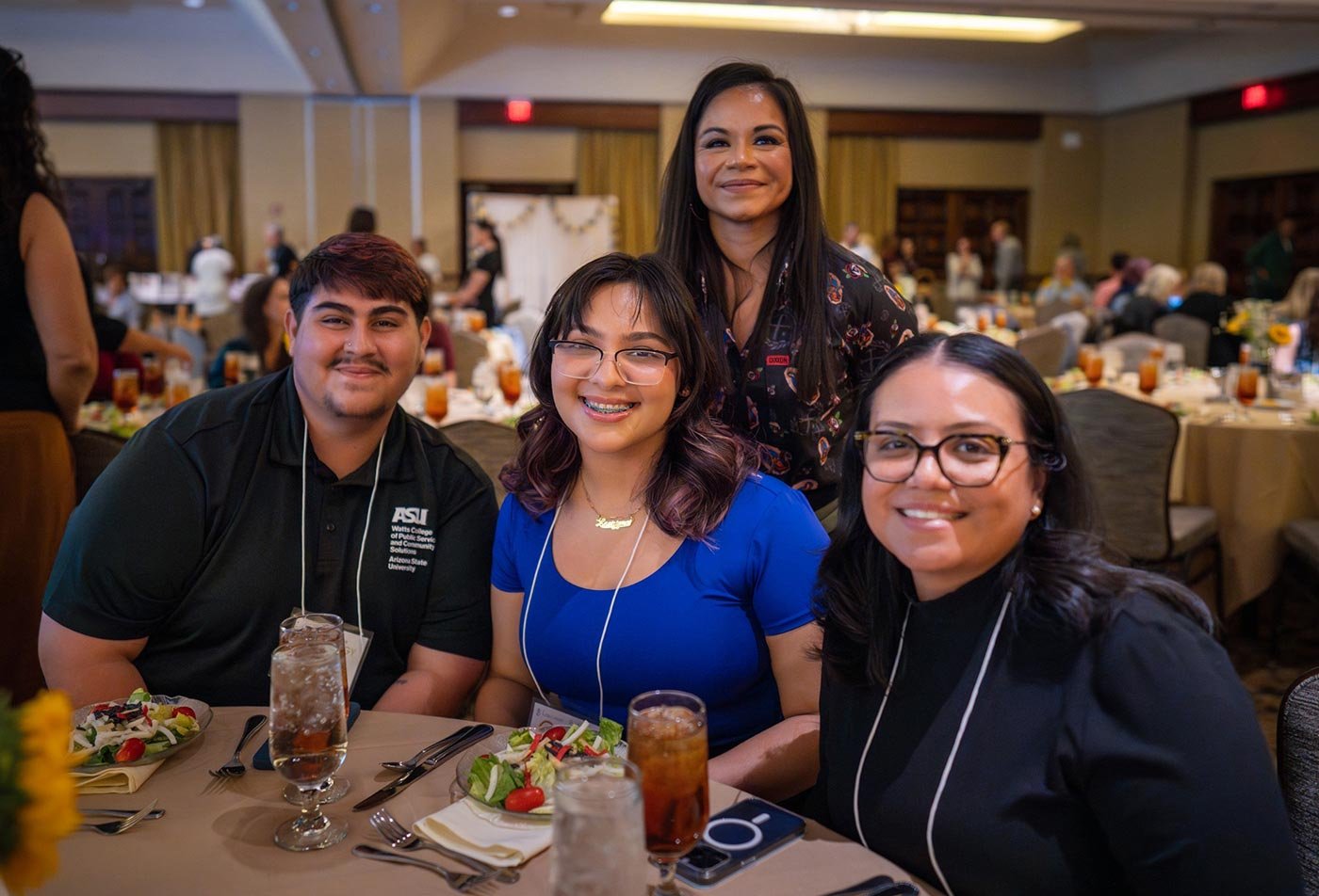 Four people share salads and conversation at an outdoor table, reflecting the networking built through ASU's Nonprofit Professional certificate.
