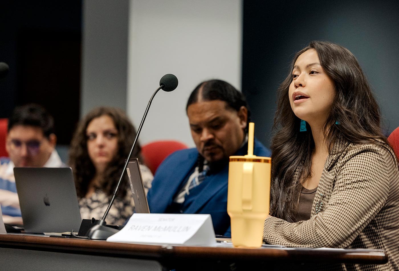 Students engage in a discussion at a conference table, showcasing collaborative learning in ASU's Public Service and Public Policy program.