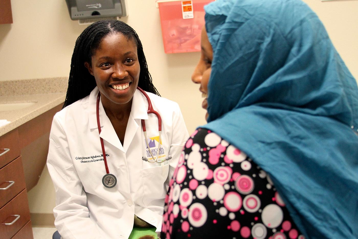 A doctor and patient talk in a healthcare setting, reflecting the interpersonal focus of ASU's Health Policy concentration.