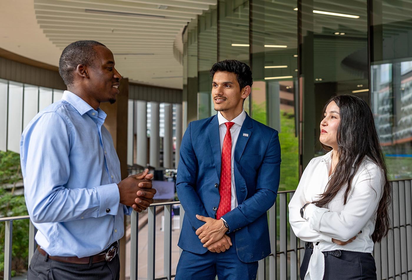 Students talk together in a modern building, reflecting the networking central to ASU's Public Finance concentration.