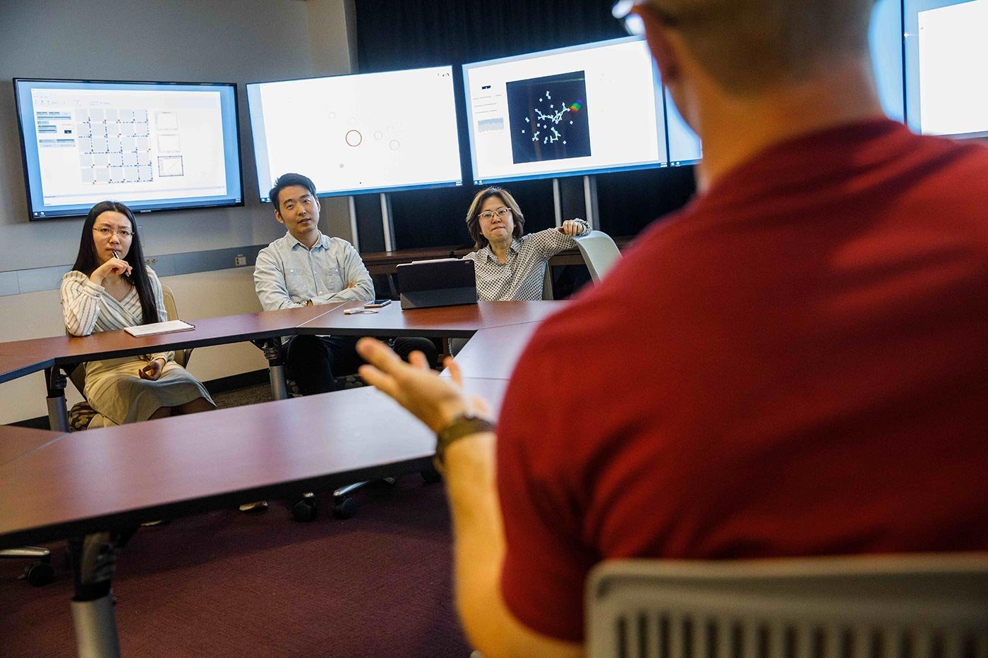 Students review data on screens during a table discussion, reflecting the analytical skills built in ASU's Program Evaluation certificate.