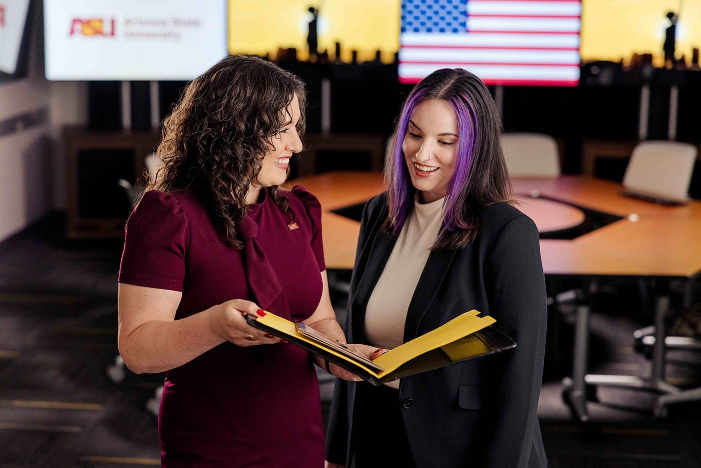 Students review materials together in a conference room, reflecting the collaborative focus of ASU's Policy Informatics concentration.