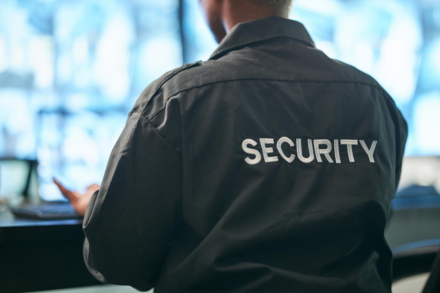 A security officer monitors security cameras, demonstrating principles explored in ASU’s certificate program in Security Studies.
