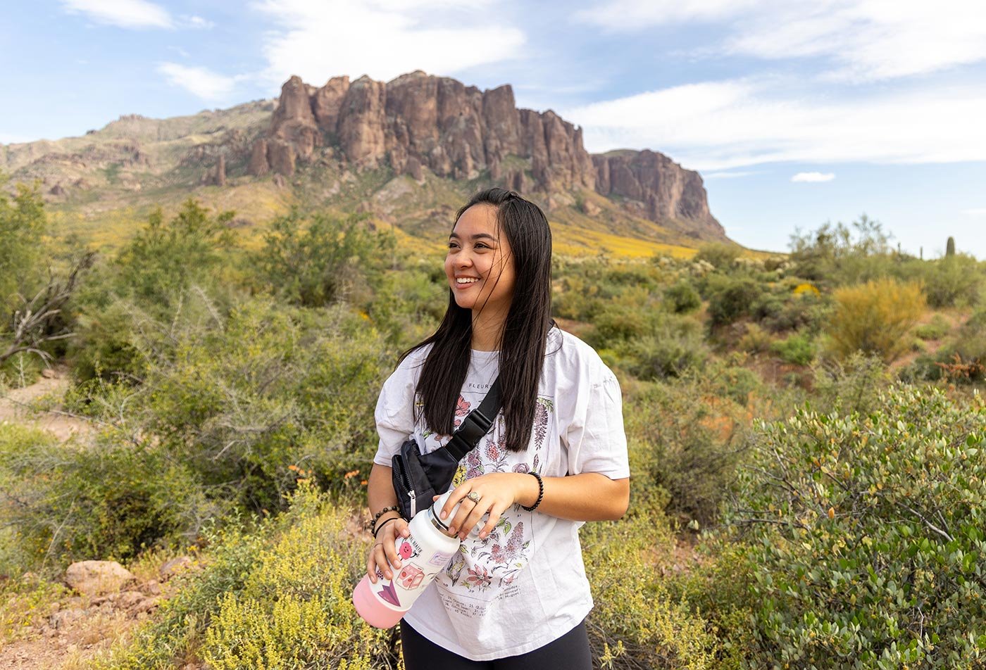 A student enjoys a vibrant desert landscape, embodying the sustainable tourism path within ASU's Tourism Development degree.