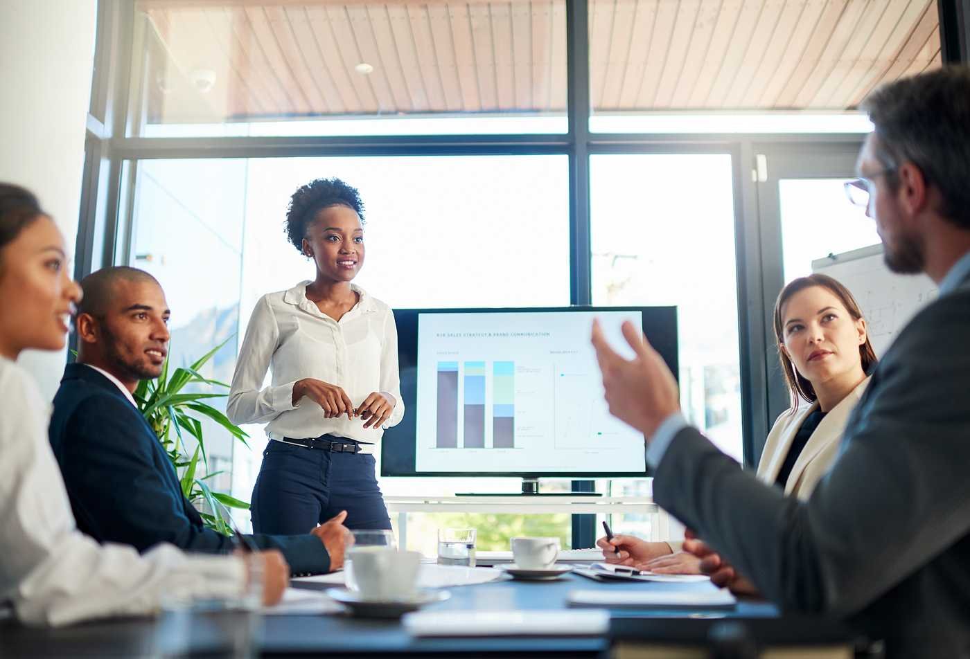 A presenter leads a meeting with digital visuals, showing innovation in ASU's Global Management (Global Development and Innovation), MGM program.