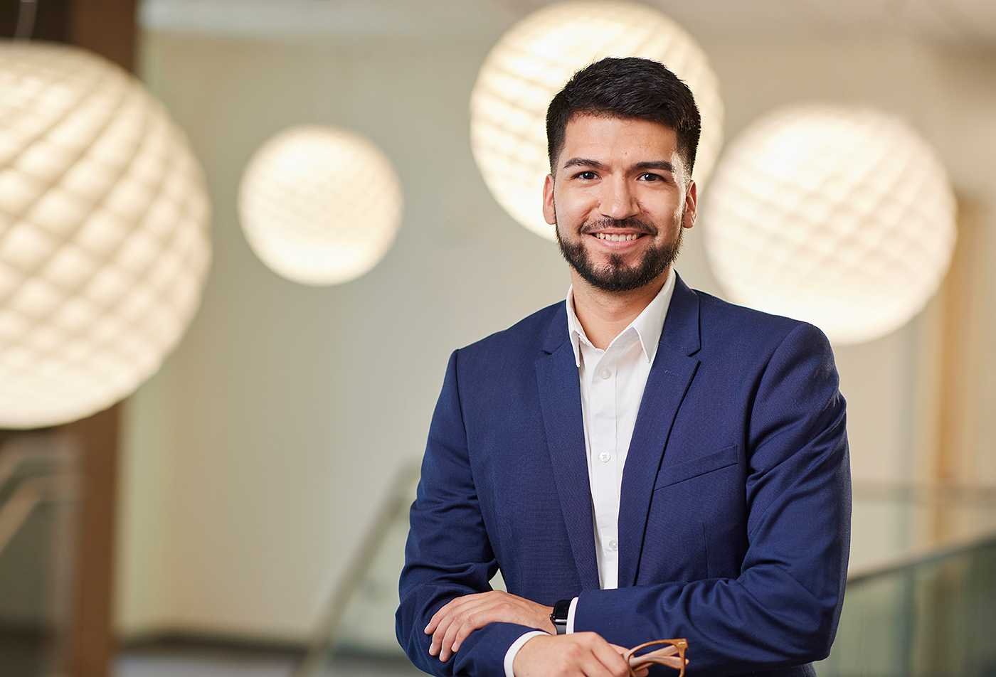 A business professional poses in a corporate setting, representing global business opportunities in ASU's International Trade program.