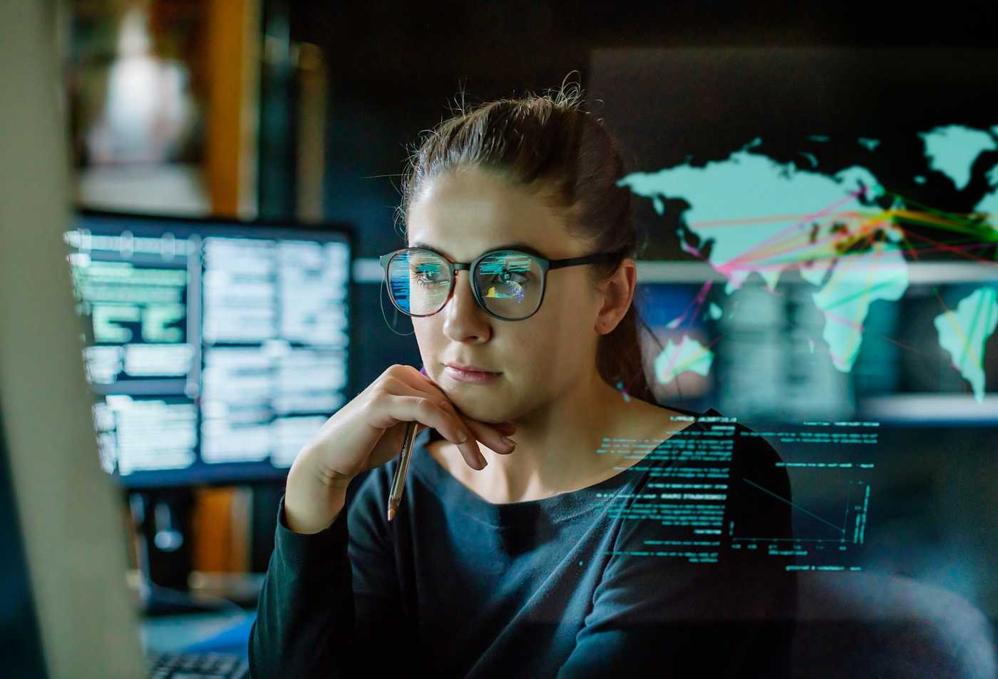 A student works on a computer in a modern workspace, developing international business skills in ASU's International Trade program.
