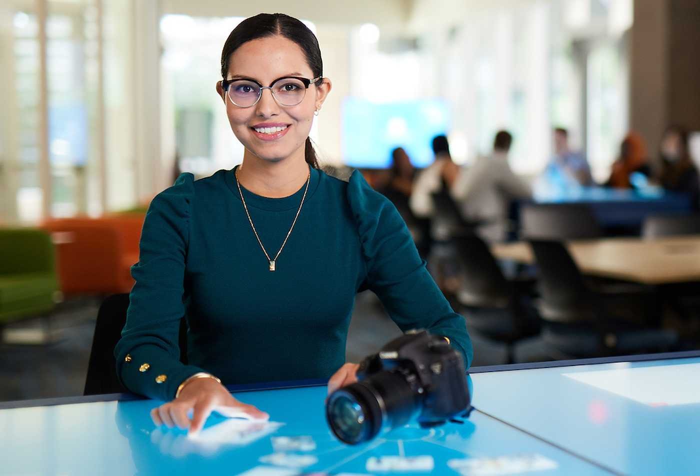 A professional presents work on a digital display, reflecting innovation in ASU's Leadership and Management (Global Creative Industries), MLM program.
