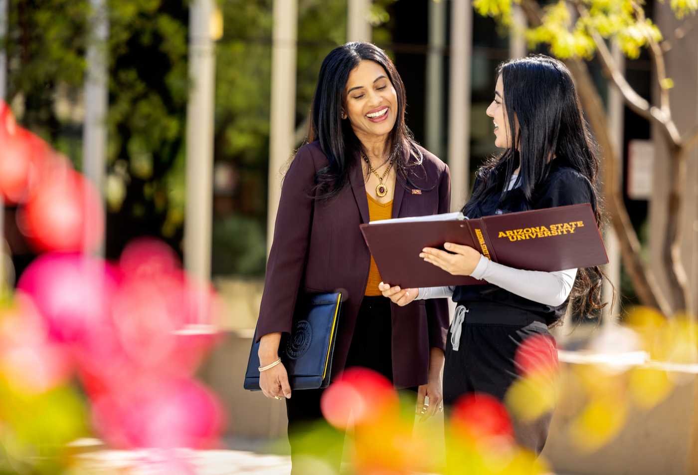 Two professional discuss policy on university campus, demonstrating the expertise gained in the MA in Educational Policy.