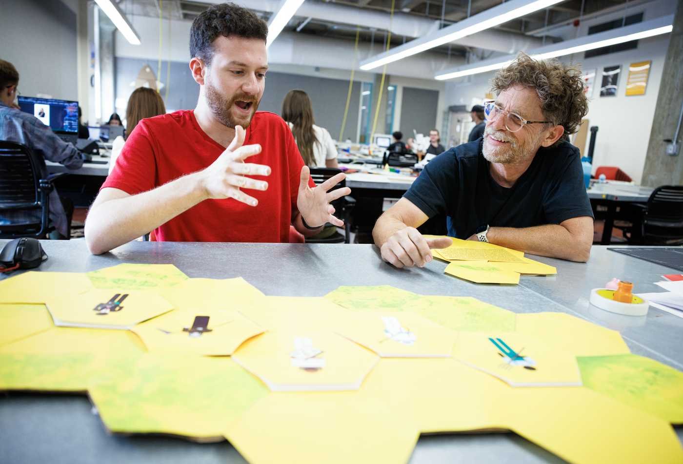 A student and faculty member create hands-on learning materials, showcasing the field mastered in the MEd in Learning Design and Technologies.