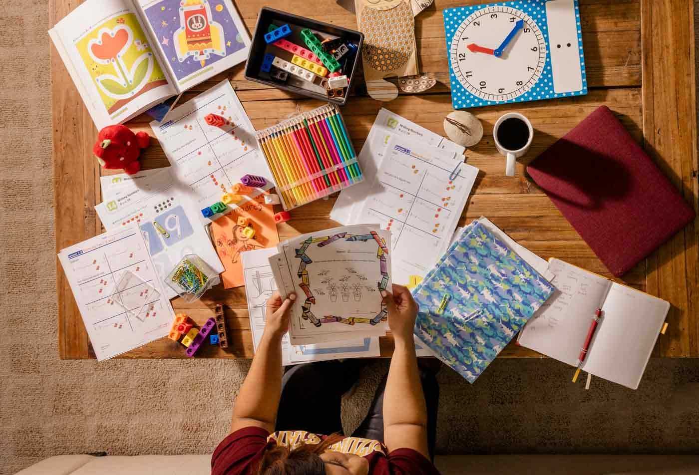 A student explores a table full of teaching materials, examining the field explored in the BAS in Applied Science (Early Childhood Studies).