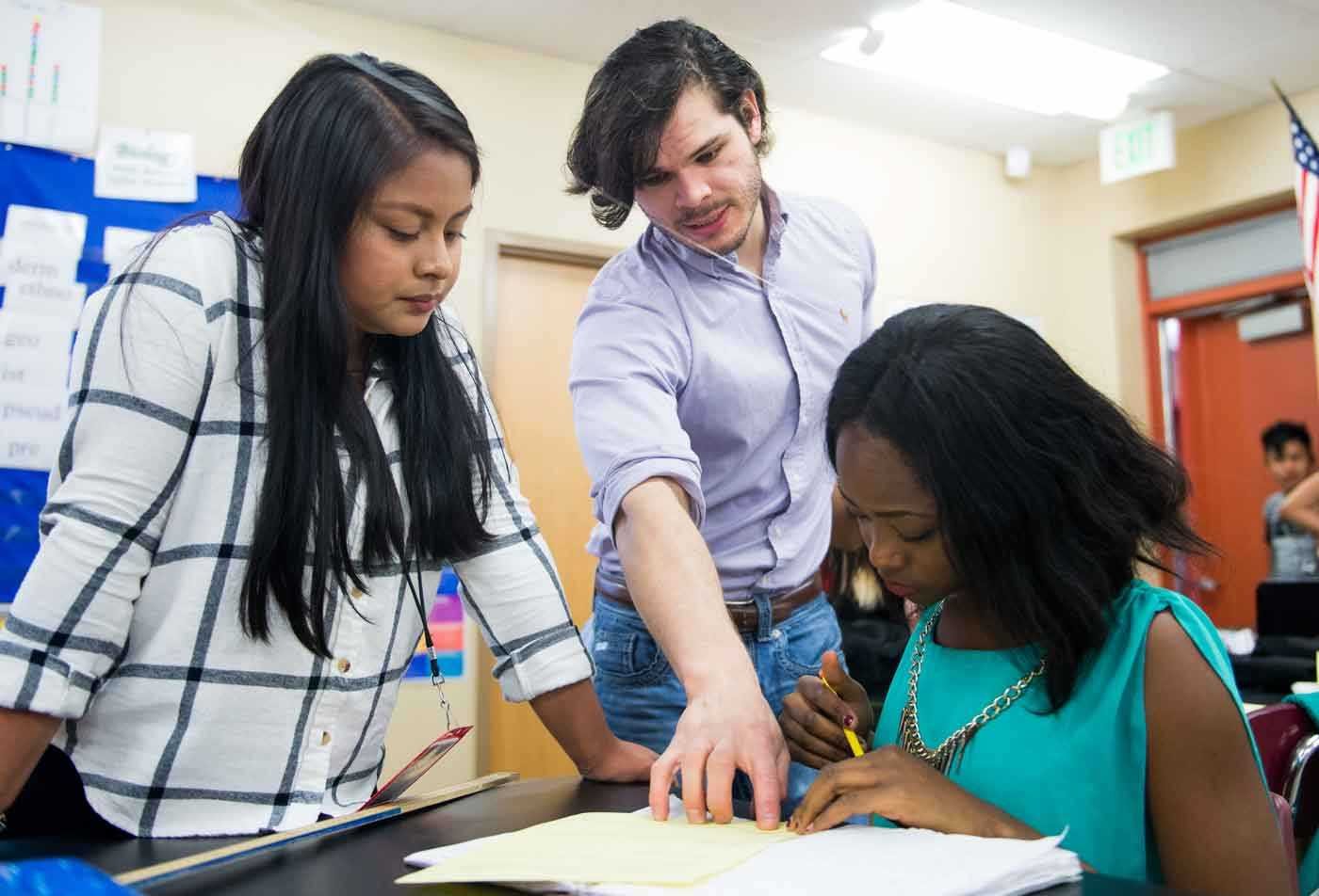 Secondary Education (Biological Sciences) students collaborate over a notebook, demonstrating teamwork in the BAE program.
