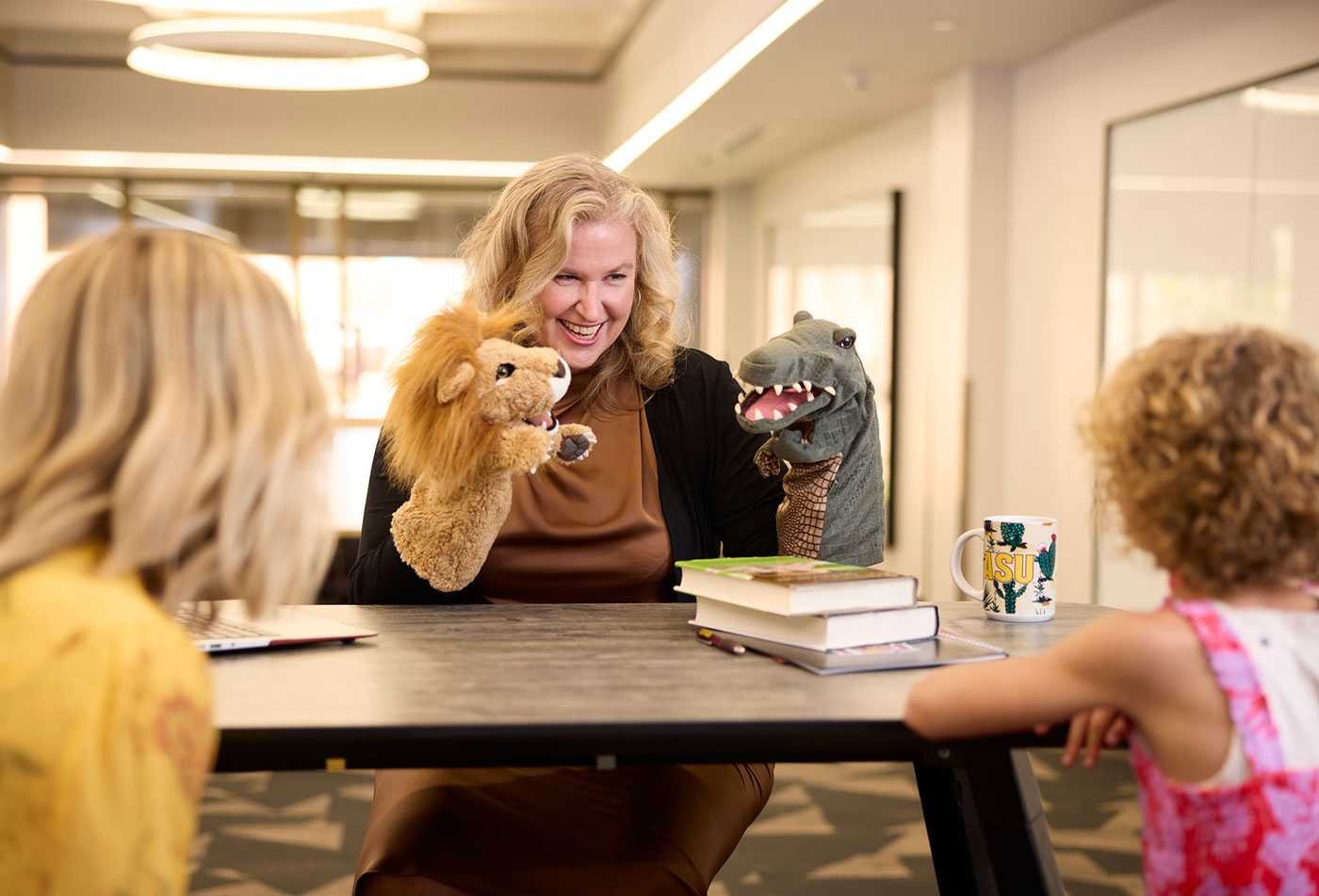 A teacher plays with puppets with children, showcasing the field explored in MEd in Early Childhood Special Education