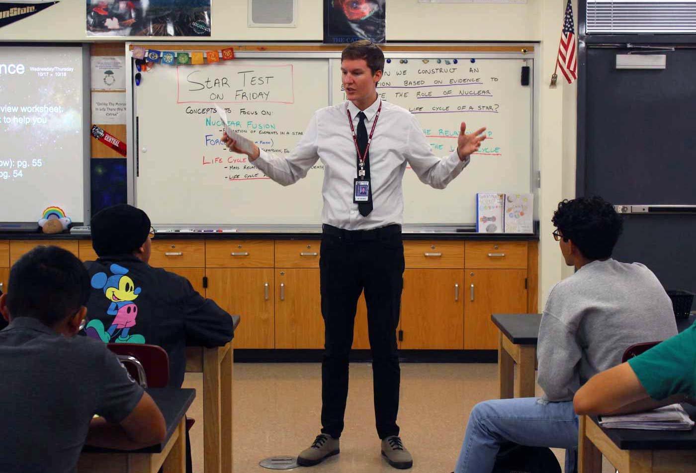 A teacher stands in an attentive classroom, using the skills gained in the BAE in Secondary Education (English).