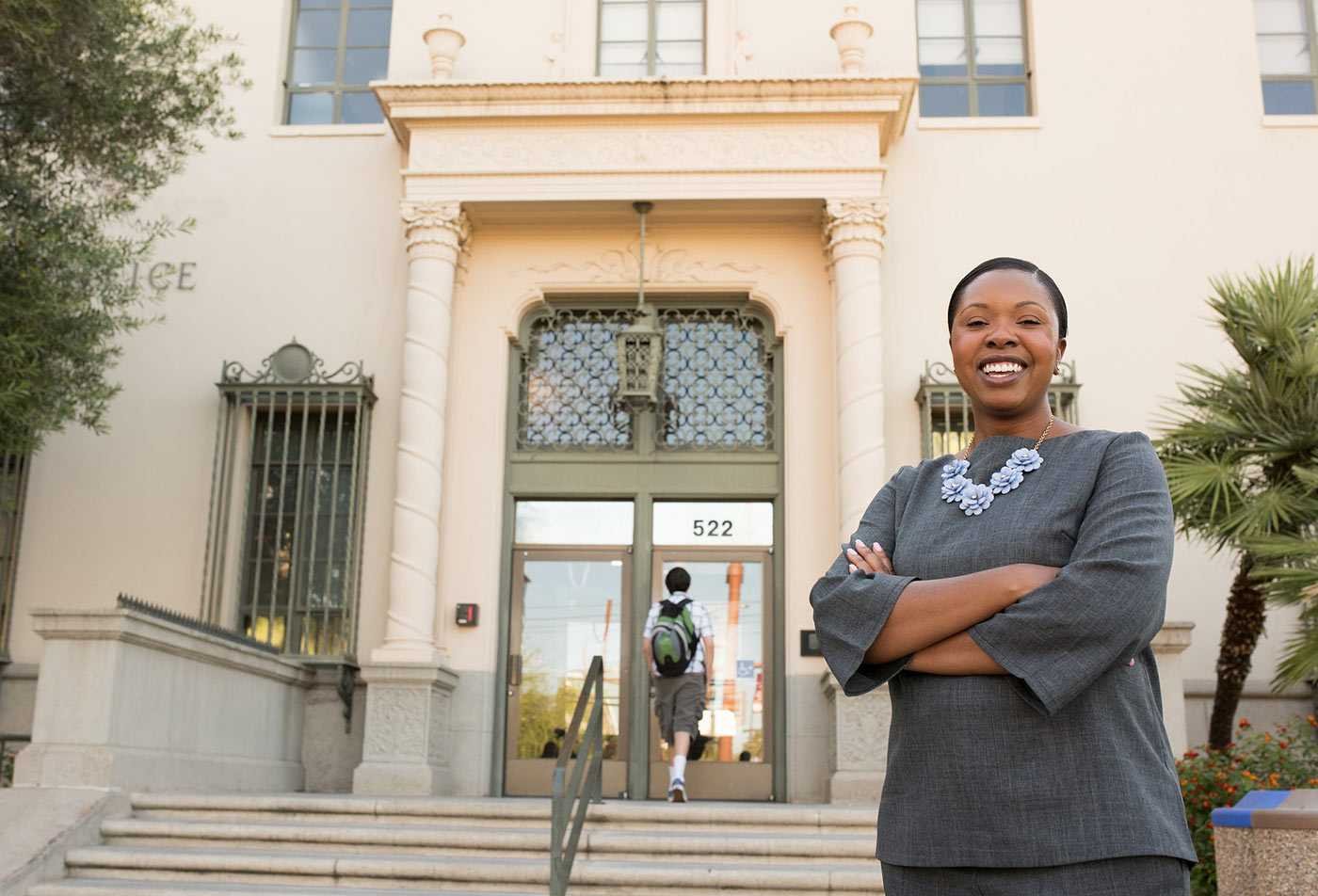 A professional poses outside a government building, showcasing the leadership skills gained in the EdD in Leadership and Innovation.