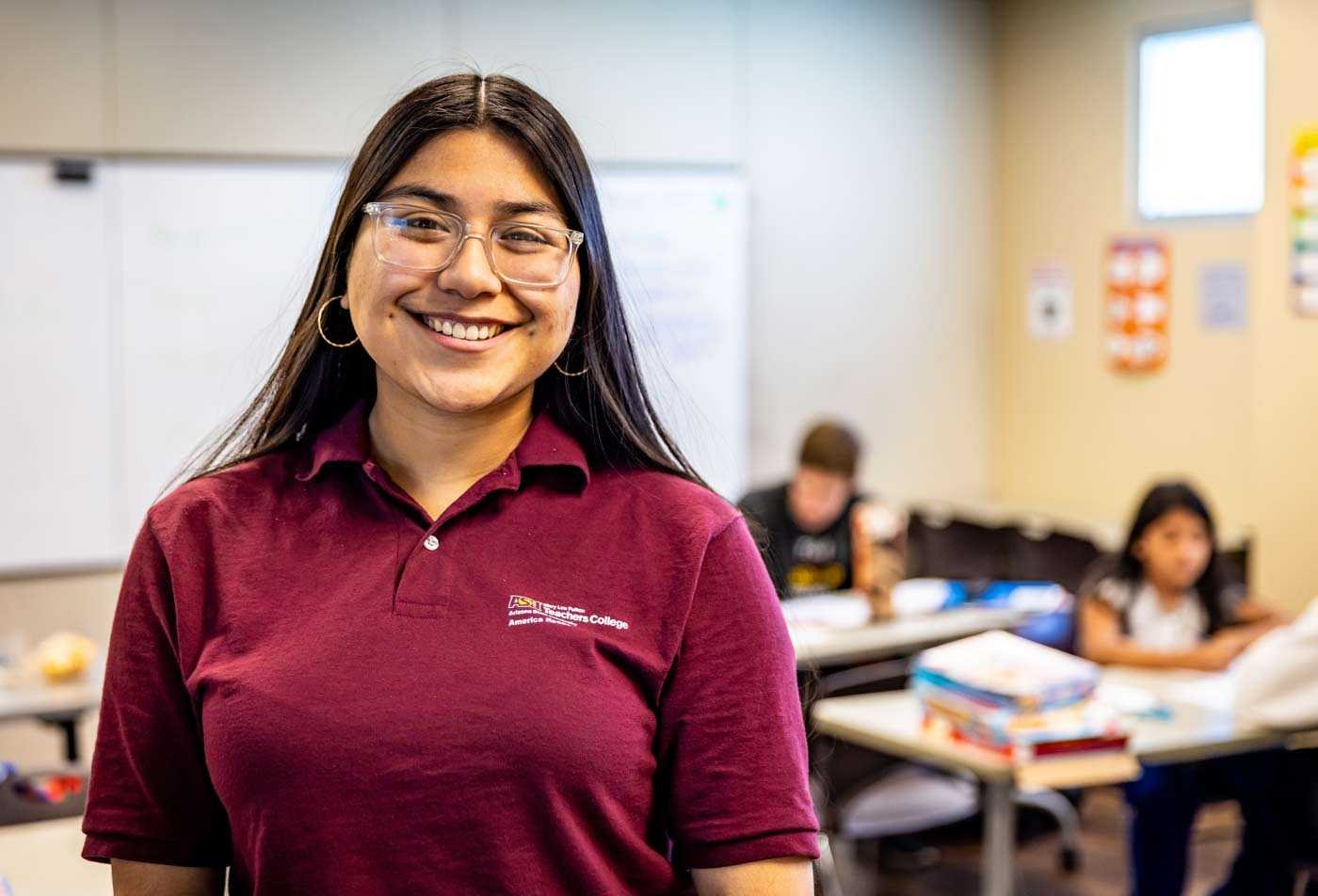 An ASU student smiles during her practical student teaching experience, highlighting hands-on learning in the BAE in Middle Grades Education.