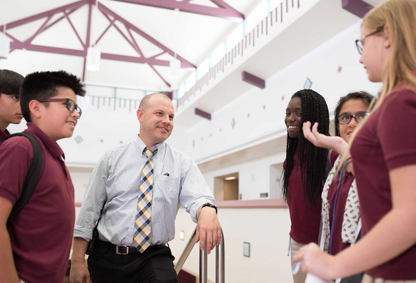 A principal engages in conversation with his students, demonstrating the field explored in the MEd in Educational Leadership (Principalship).