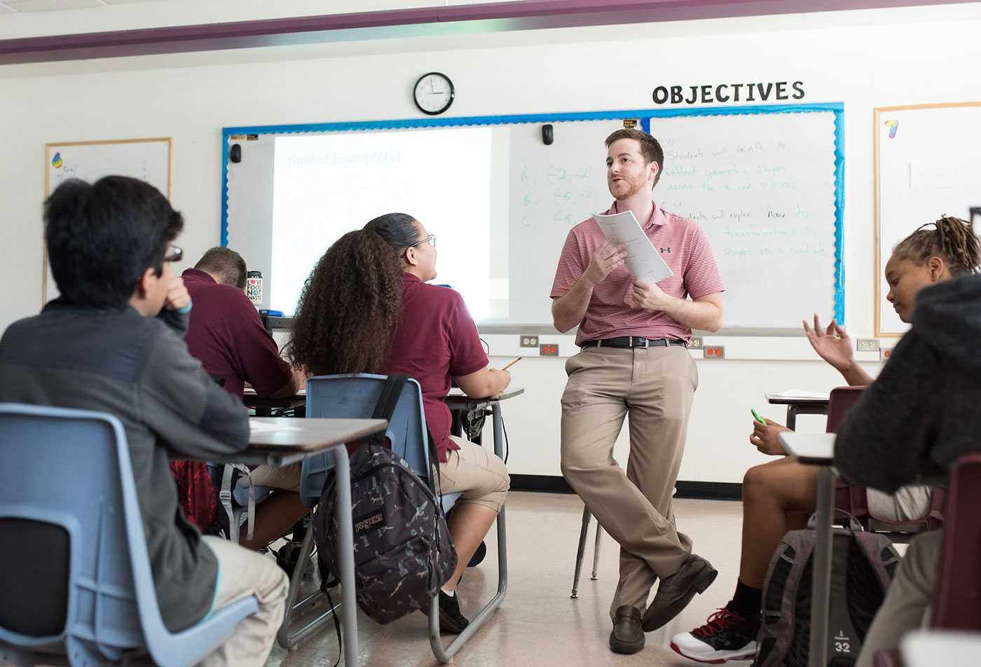 An instructor talks to his classroom of students, demonstrating the skills gained in the MEd in Secondary Education (Teacher Certification).