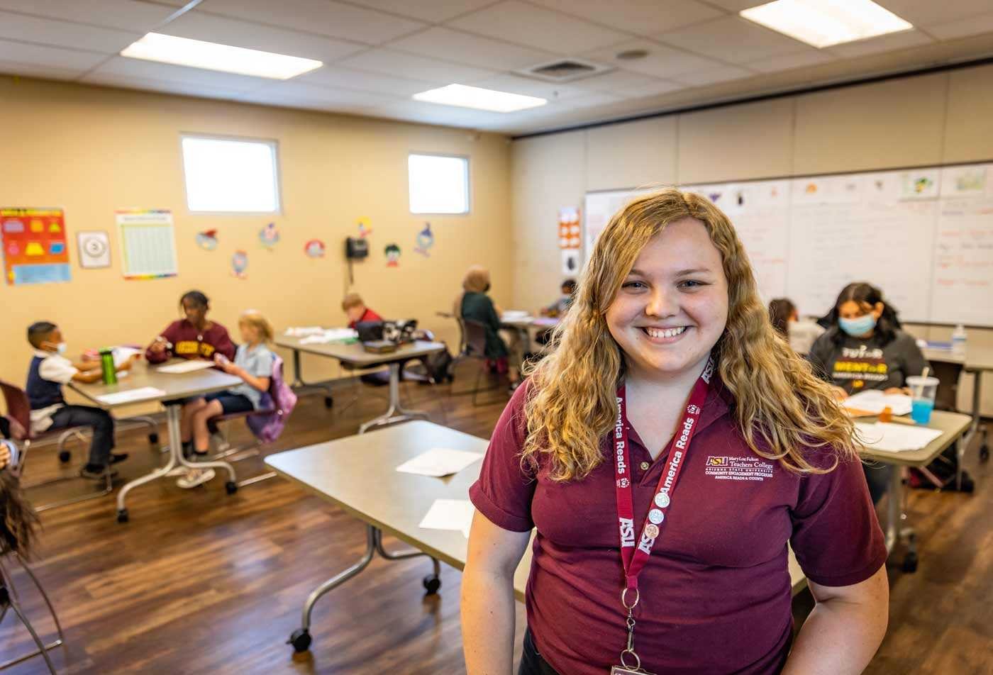 An ASU student smiles during her practical student teaching experience, highlighting hands-on learning in the BAE in Special Education.