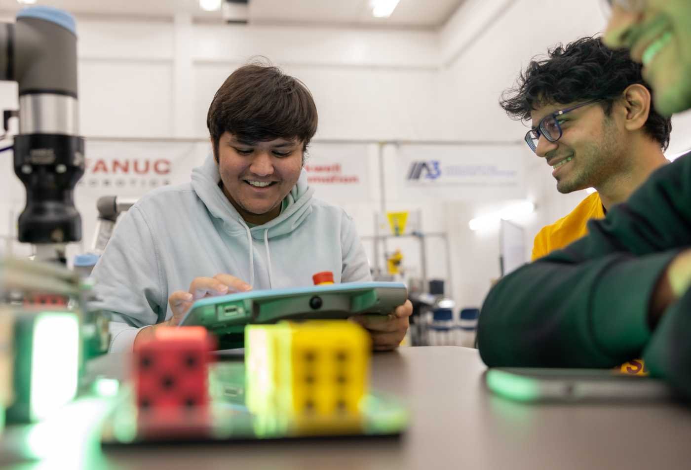 Students use robotics equipment in a lab, showcasing hands-on learning in ASU's Applied Science degree.