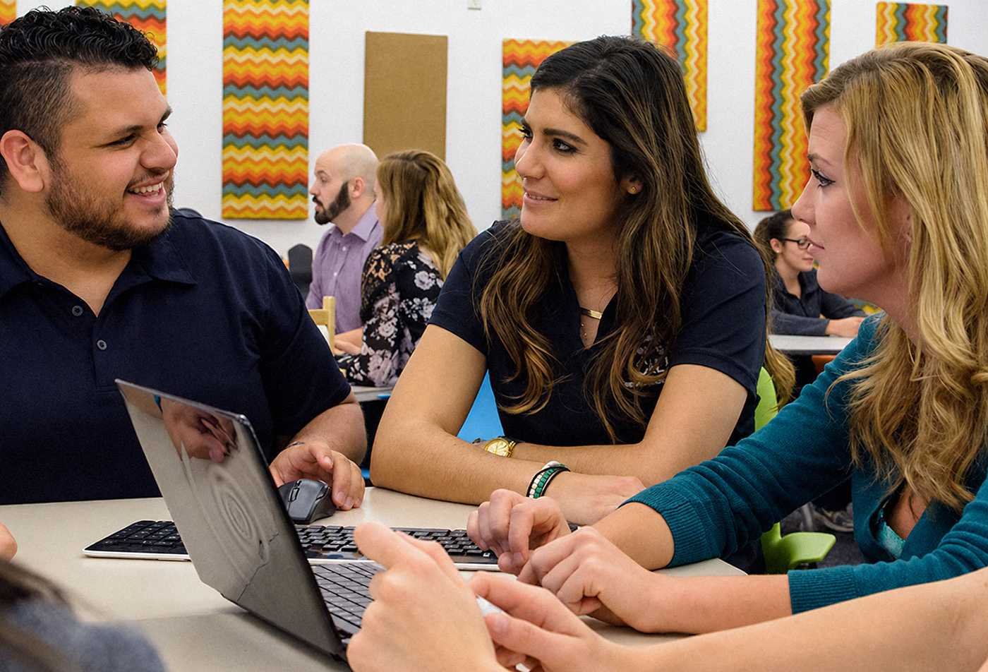 A group works together on a classroom activity, reflecting collaborative learning in ASU's Communication, BS program.