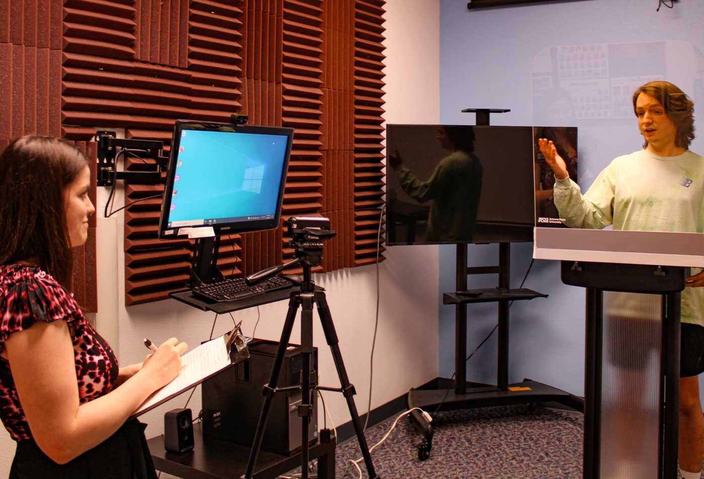 A student practices a presentation in a recording studio, building skills in ASU's Communication Training and Assessment certificate.