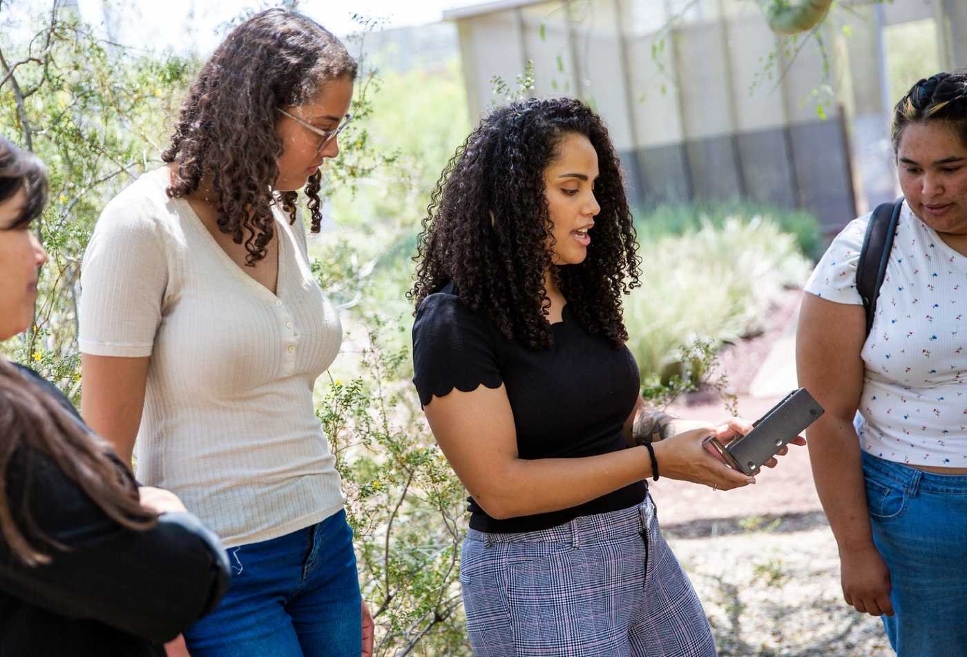 Students examine environmental conditions outdoors, supporting applied research in ASU's Environmental Science minor.