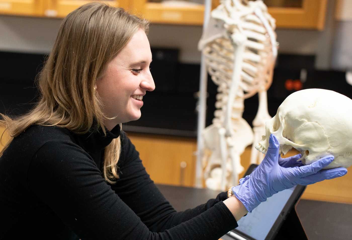 A researcher examines evidence under ultraviolet light, demonstrating investigative techniques in ASU's Forensic Science, BS program.