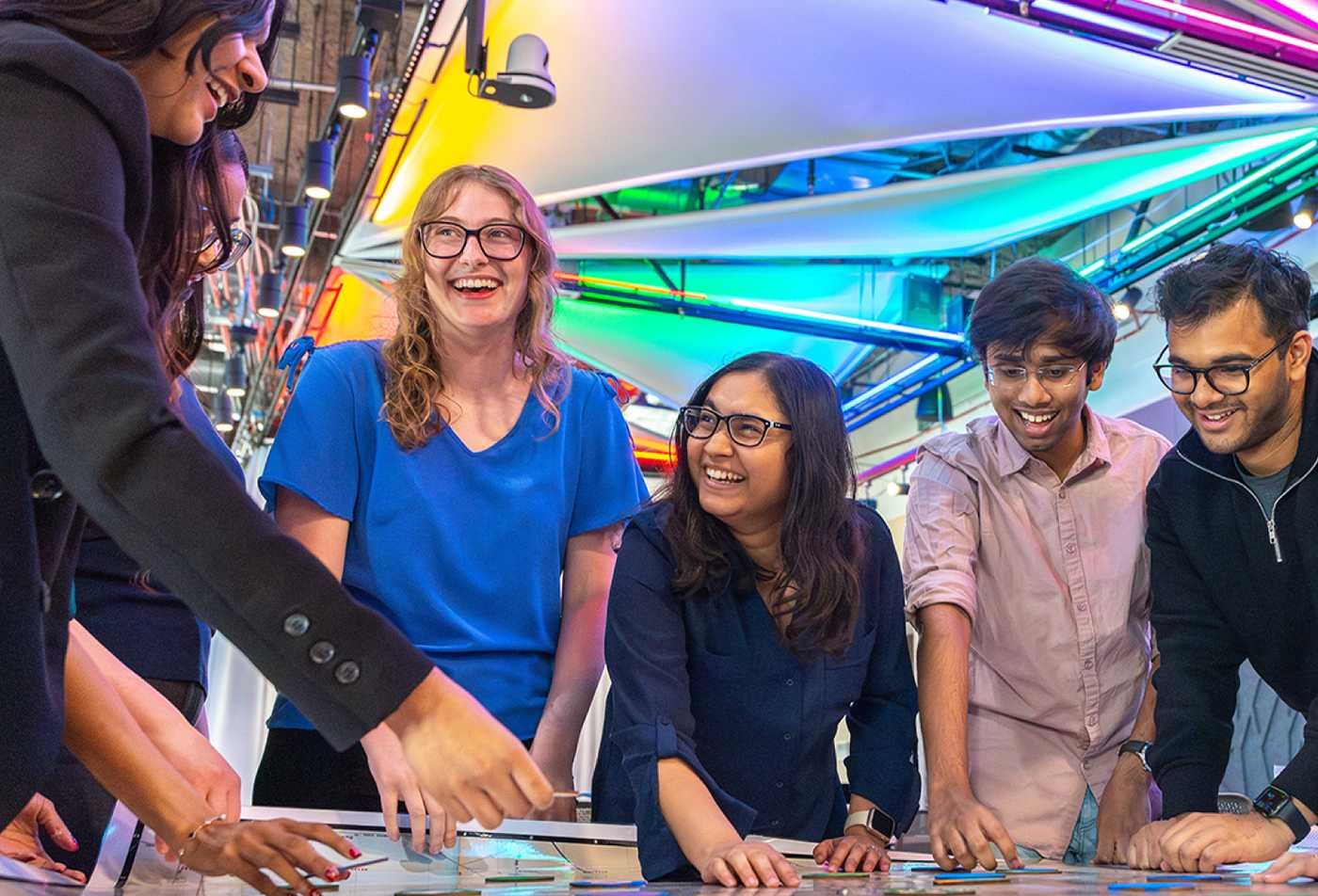 Students collaborate around an interactive table, exploring creative fields in ASU's Exploratory Humanities, Fine Arts and Design program.