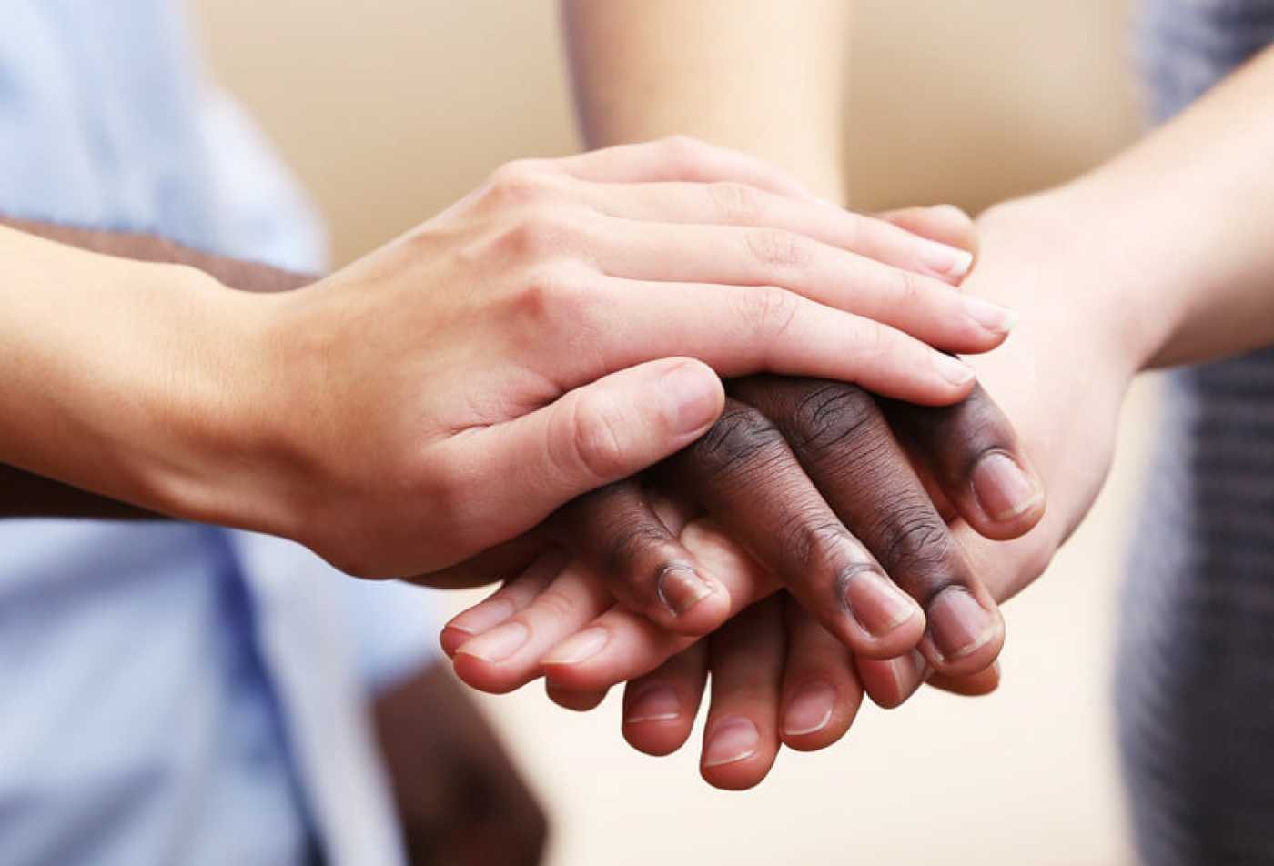 Hands join together to symbolize collaboration and solidarity in ASU's Social Justice and Human Rights, MA program.