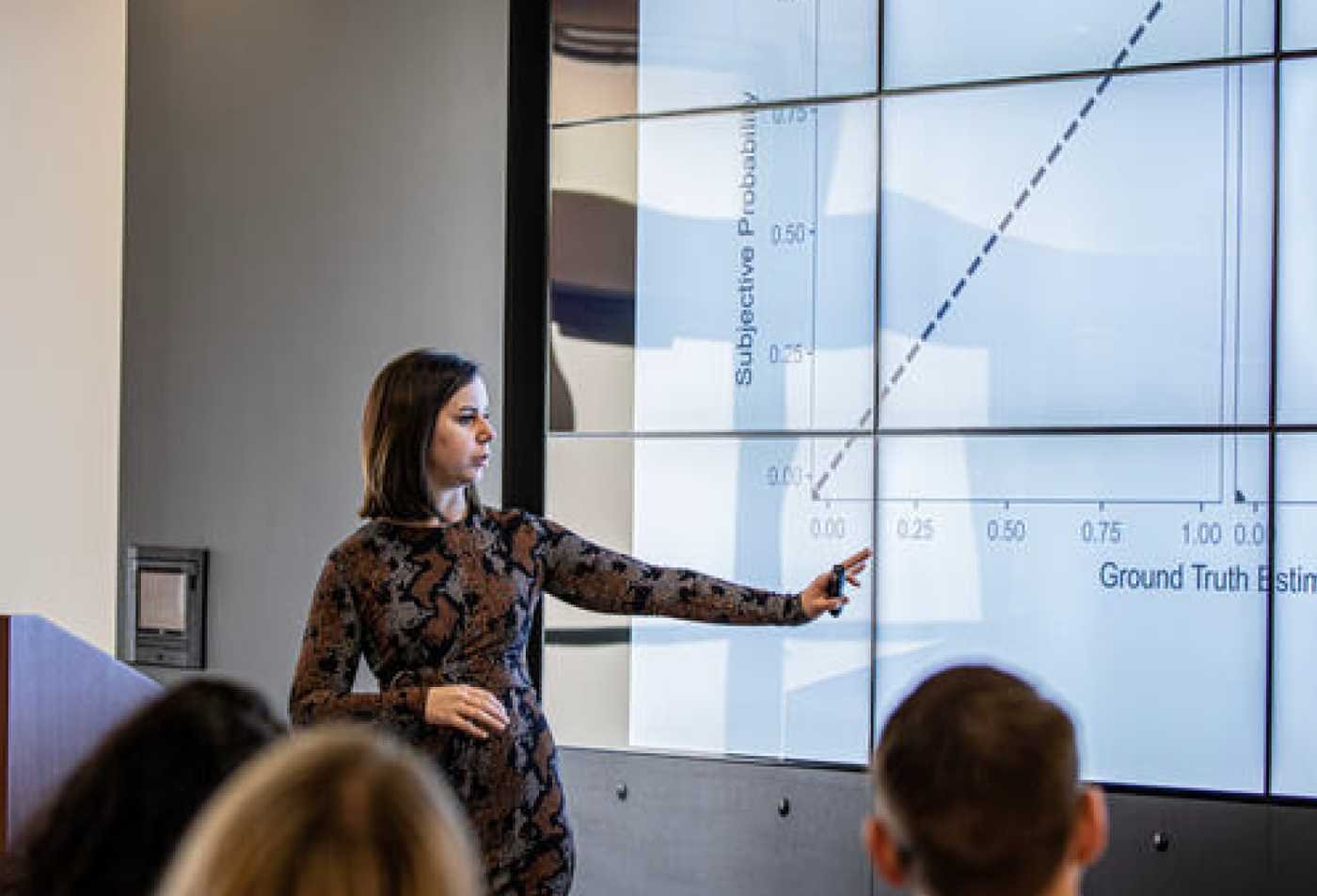 An instructor presents research data to a class, connecting behavior and evidence in ASU's Law and Psychology, PhD program.