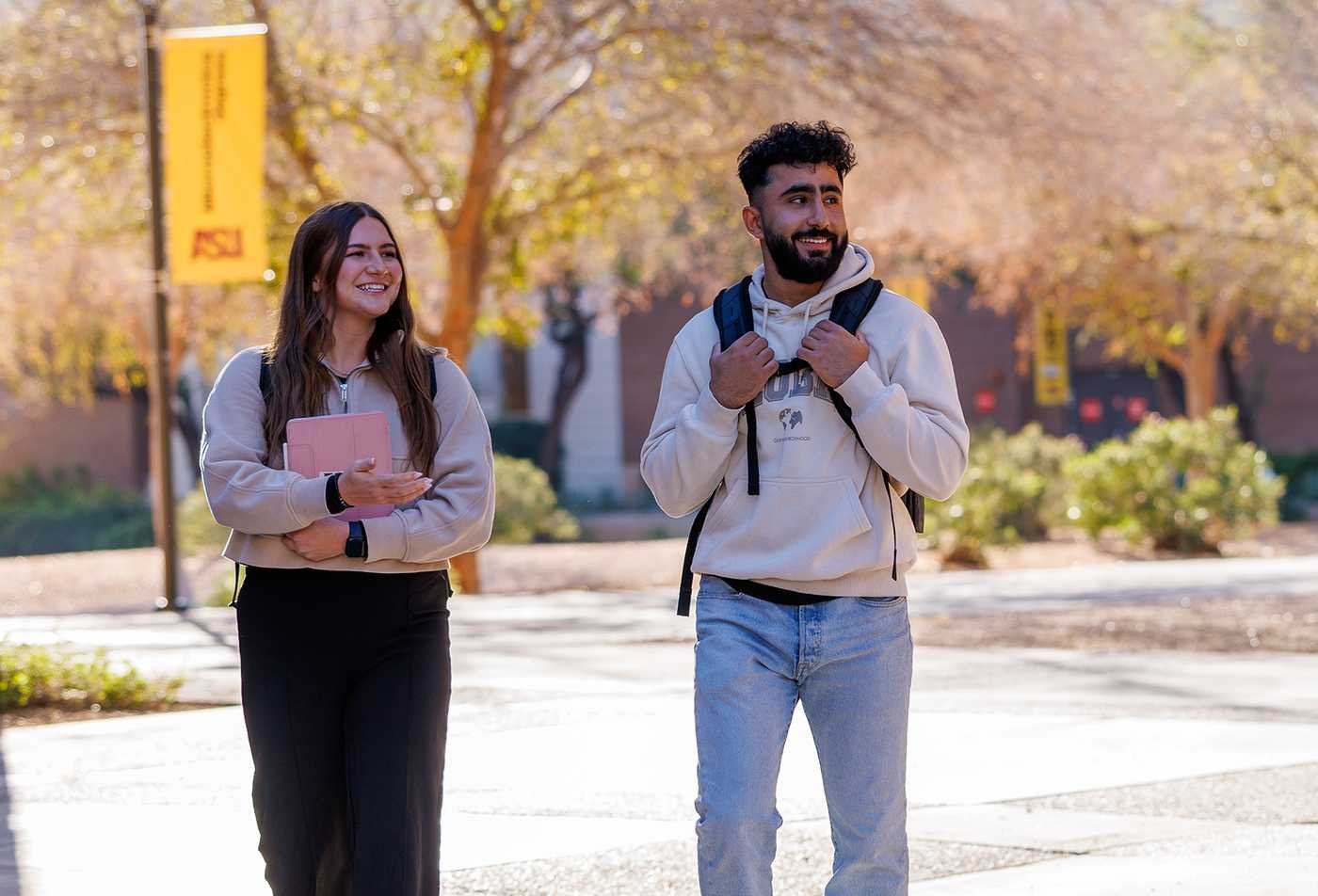 Students engage in dicussion as they walk around campus, exploring human behavior in ASU's Psychology, BA program.
