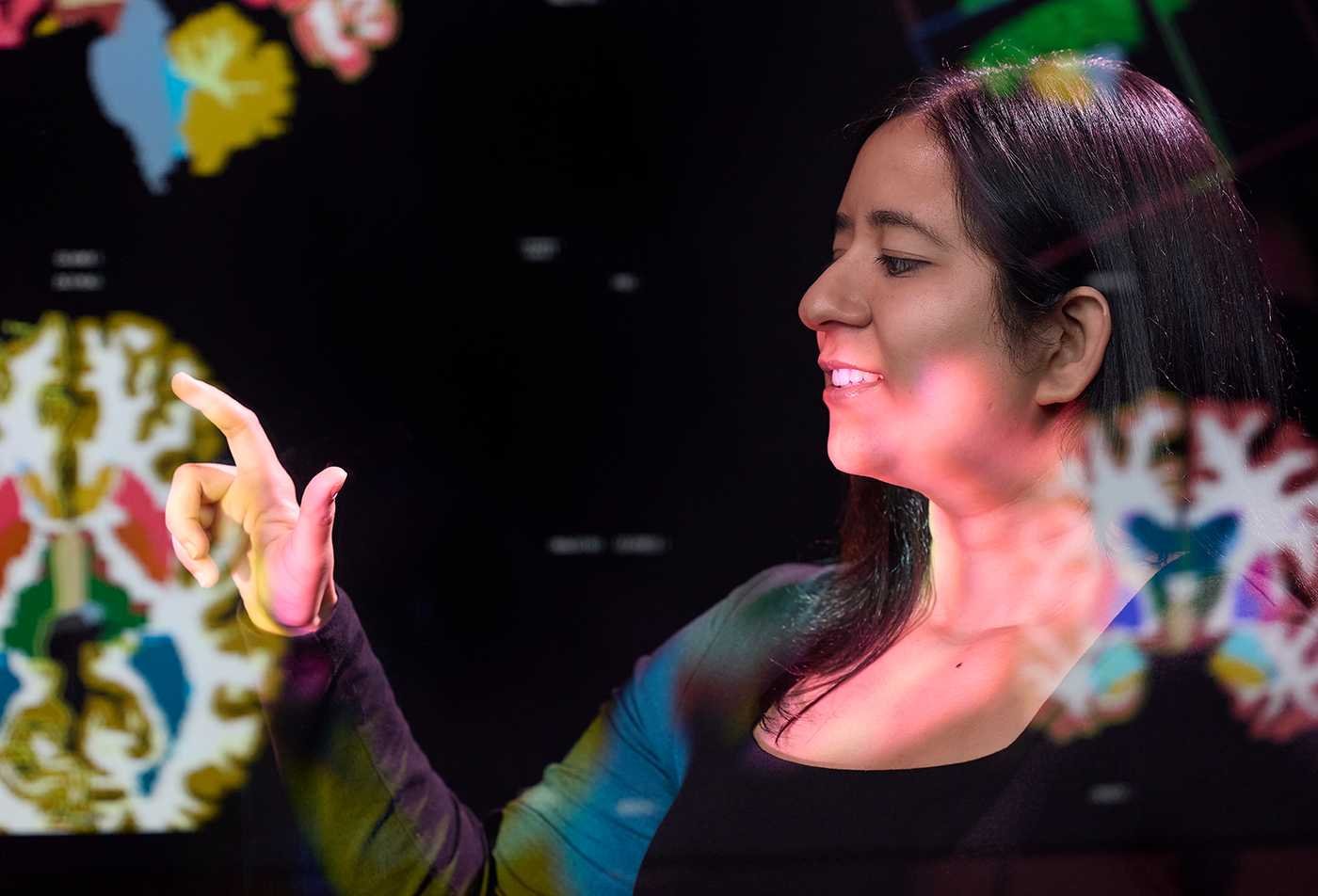 A student examines diagrams of the brain, reflecting behavior and growth in ASU's Psychology (Positive Psychology), BS program.