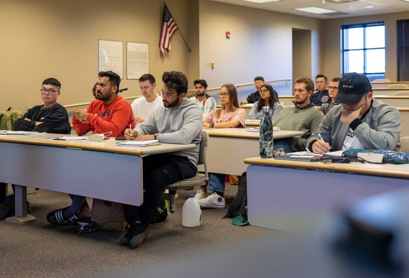 An open book surrounded by symbols of world faiths reflects diverse traditions studied in ASU's Religious Studies minor.