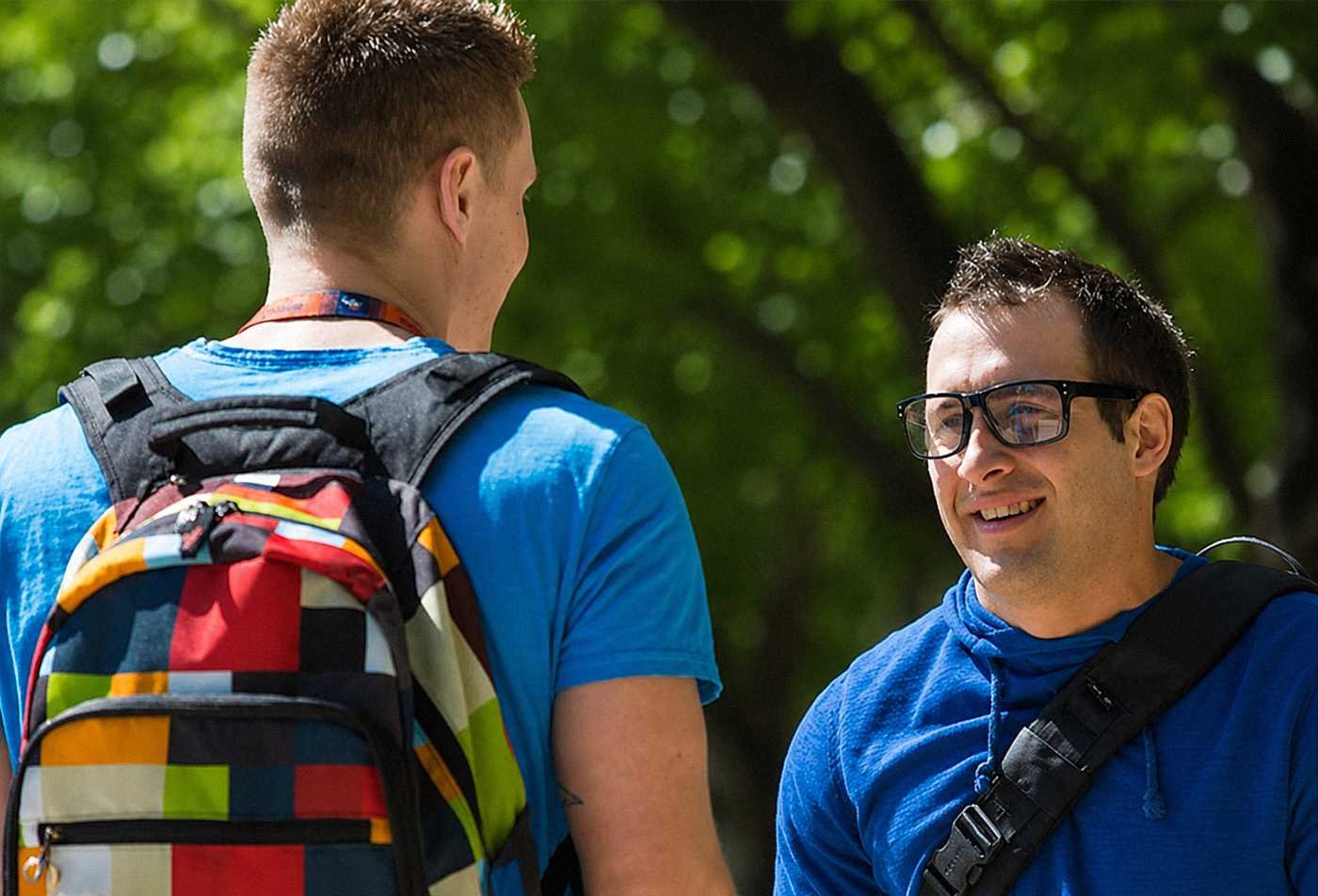 Students talk together in a campus setting, reflecting the study of communities in ASU's Sociology minor.