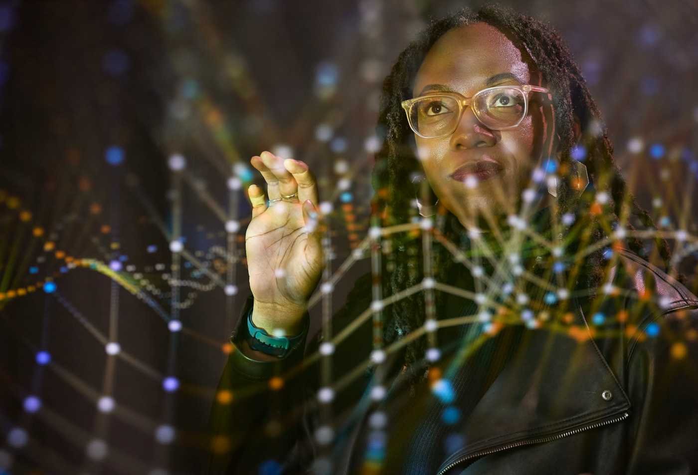 A researcher interacts with a digital data visualization, highlighting analytical inquiry in ASU's Social Data Science, MA program.