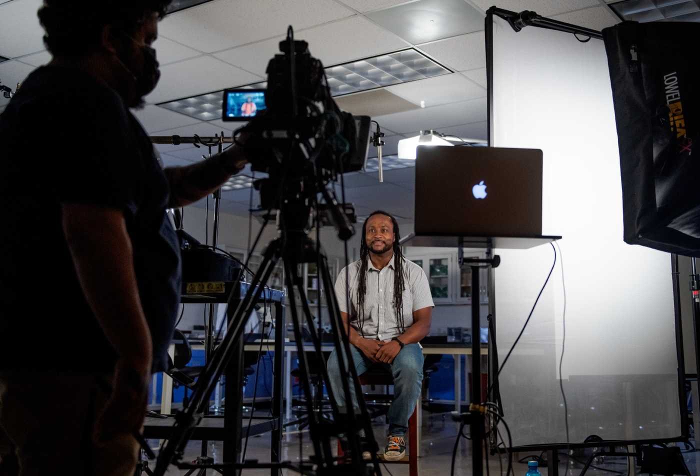 A camera crew records an interview in a studio, showcasing media production in ASU's Film and Video Studies certificate.